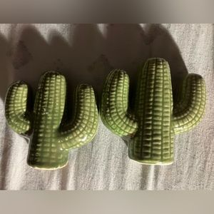Vintage salt and pepper shakers shaped like cactus plants.